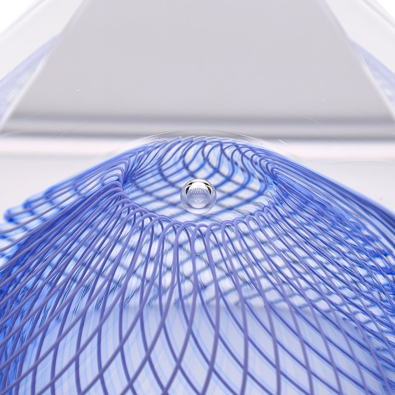 a close up of the intricate, indigo-colored cane pattern within the glass pyramid