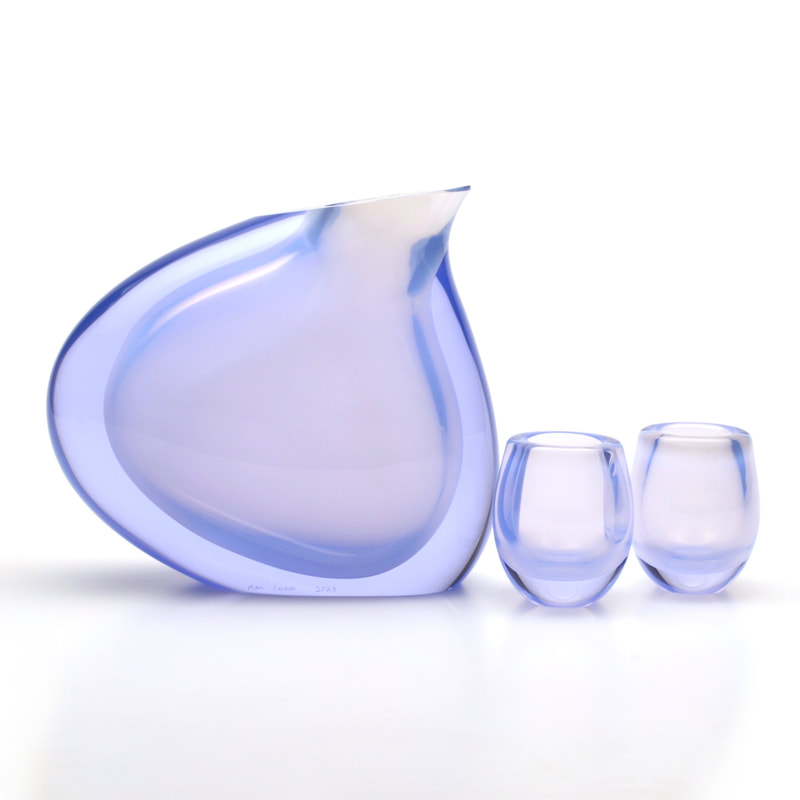 a  indigo modernist glass pitcher set sculpture with a white background