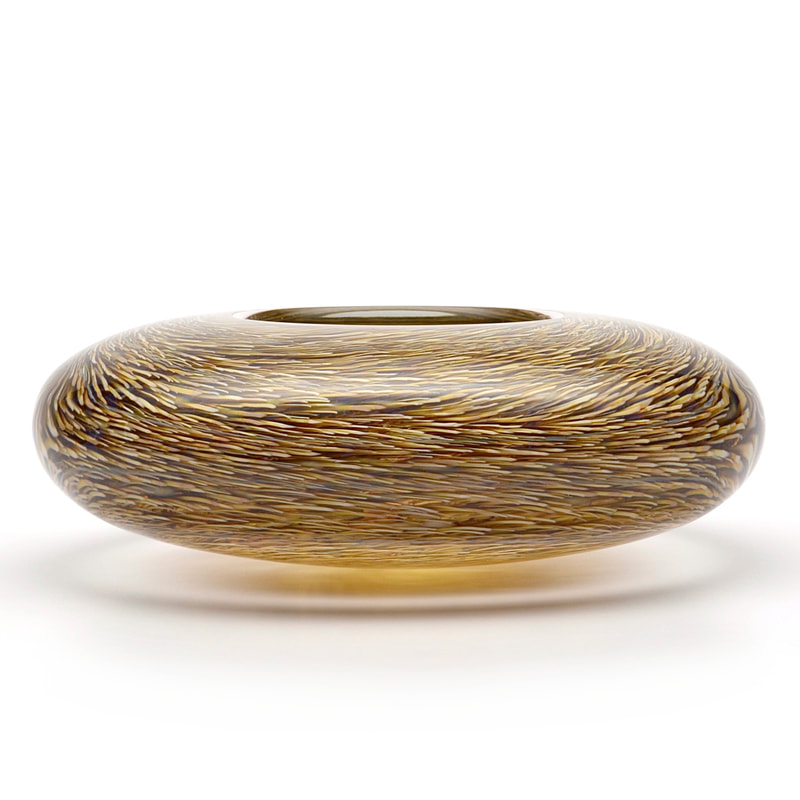 A thick, optical glass bowl with amber and gold murrini.