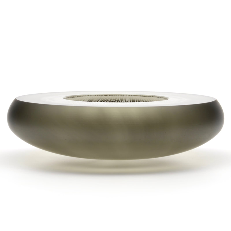 A thick, grey, modernist glass bowl.